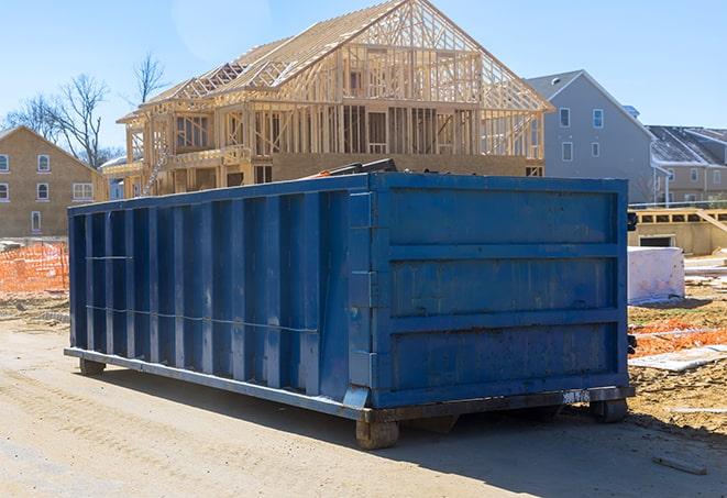 a waste management truck hauling multiple dumpsters