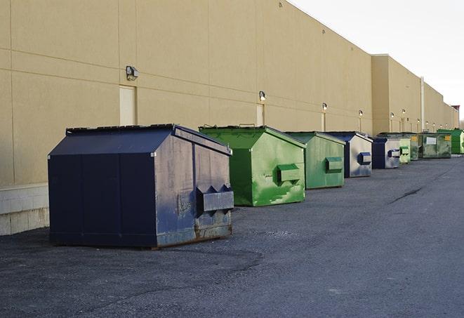 big yellow dumpsters on a construction lot in Cygnet